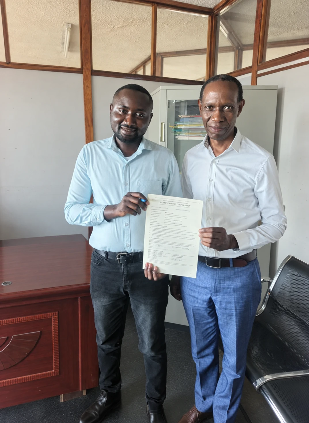 Client and service representative holding the handed-over property documents